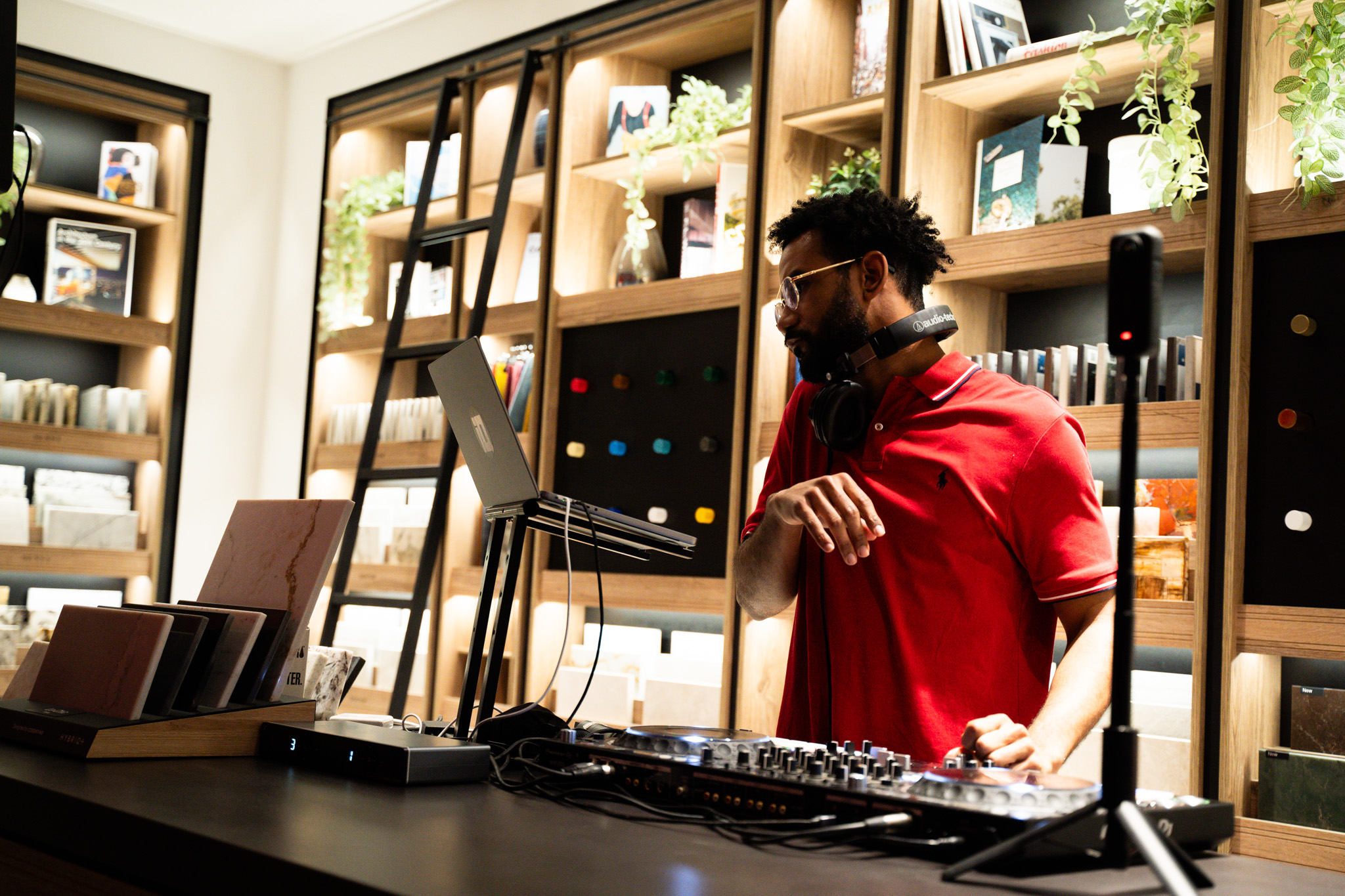 DJ IQ performing inside a modern design showroom