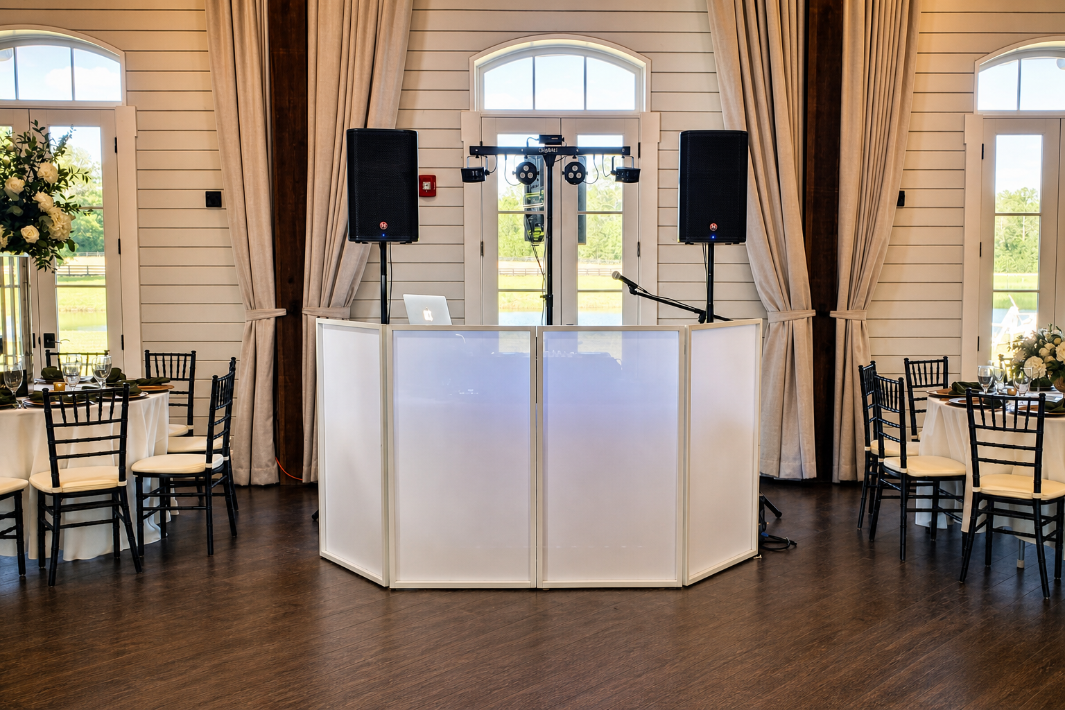 A professional DJ setup prepared inside an elegant wedding venue