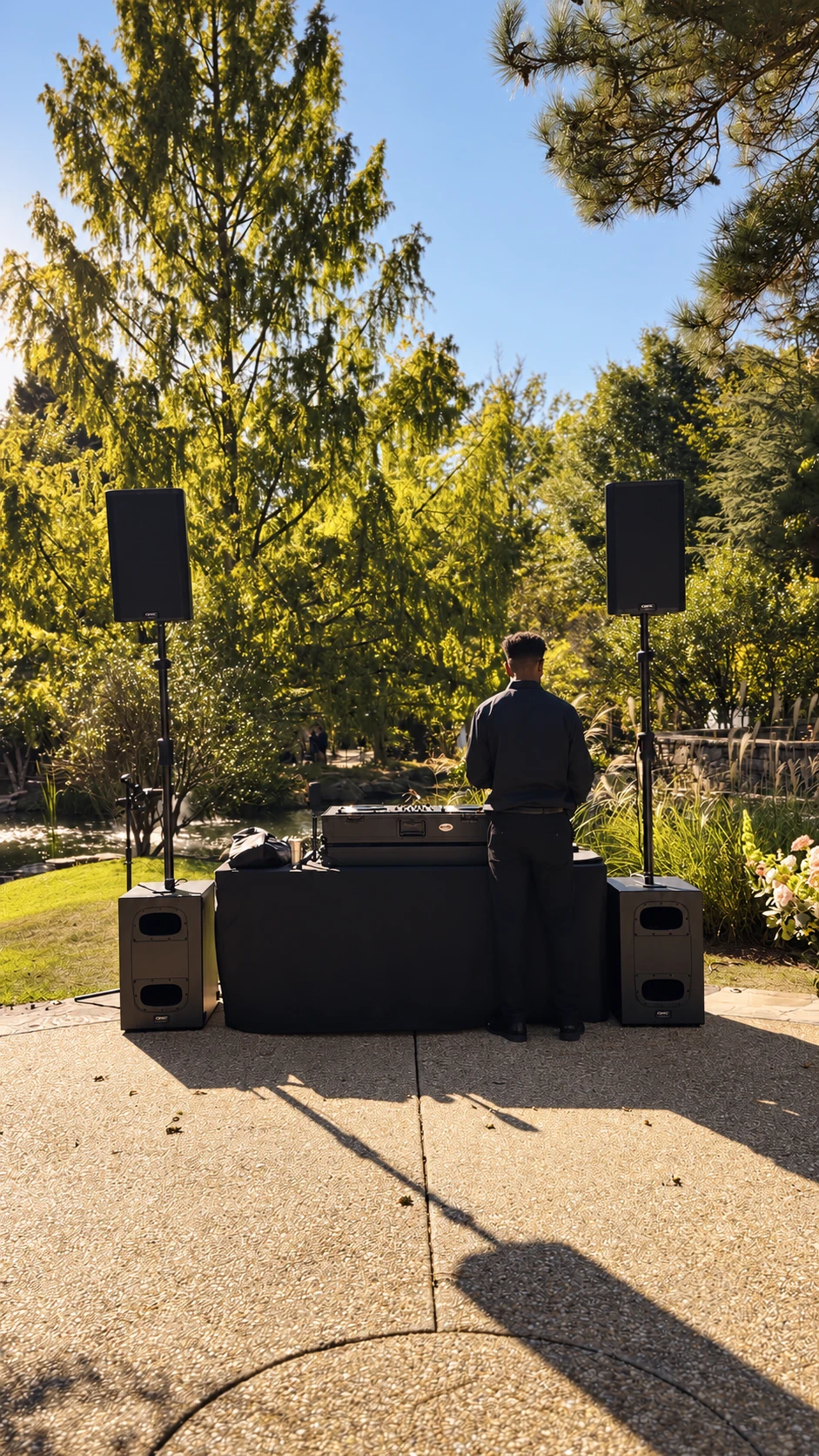 DJ IQ with a complete outdoor wedding sound system in a garden setting